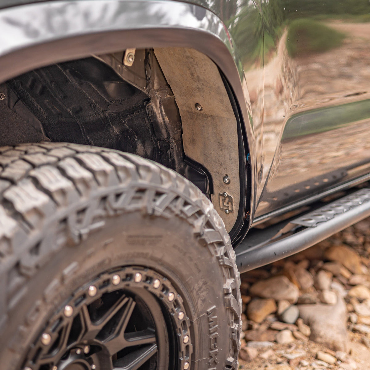 Cover photo for the C4 High Clearance Fender Liner kit for the 3rd Gen Tacoma with the liners emphasized and the rest of the photo faded out.