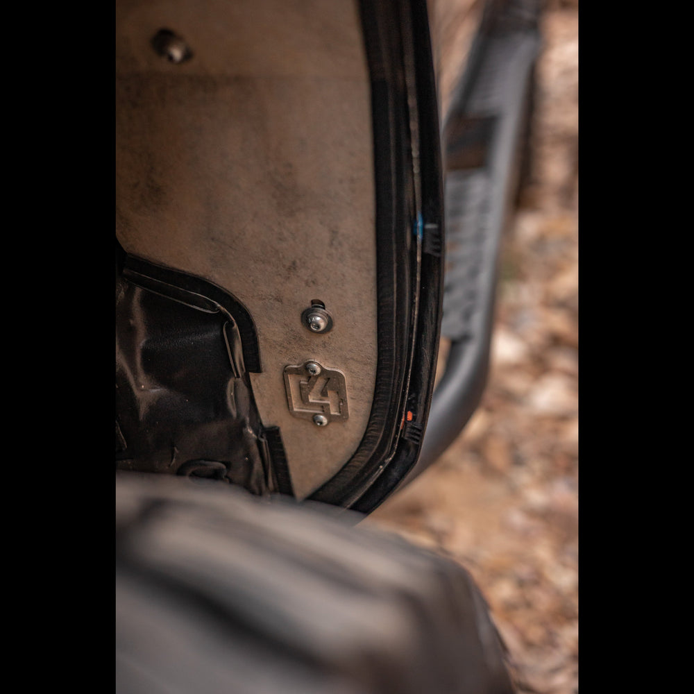 Close up view of the C4 logo on the aluminum inner fender of the High Clearance Fender Liner kit.