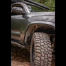 Close up view of a complete C4 Oversize Tire Fitment kit installed on a 3rd Gen Tacoma.