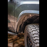 Look back through the rear of the passenger wheel well showing the installed C4 Oversize Tire Fitment kit.