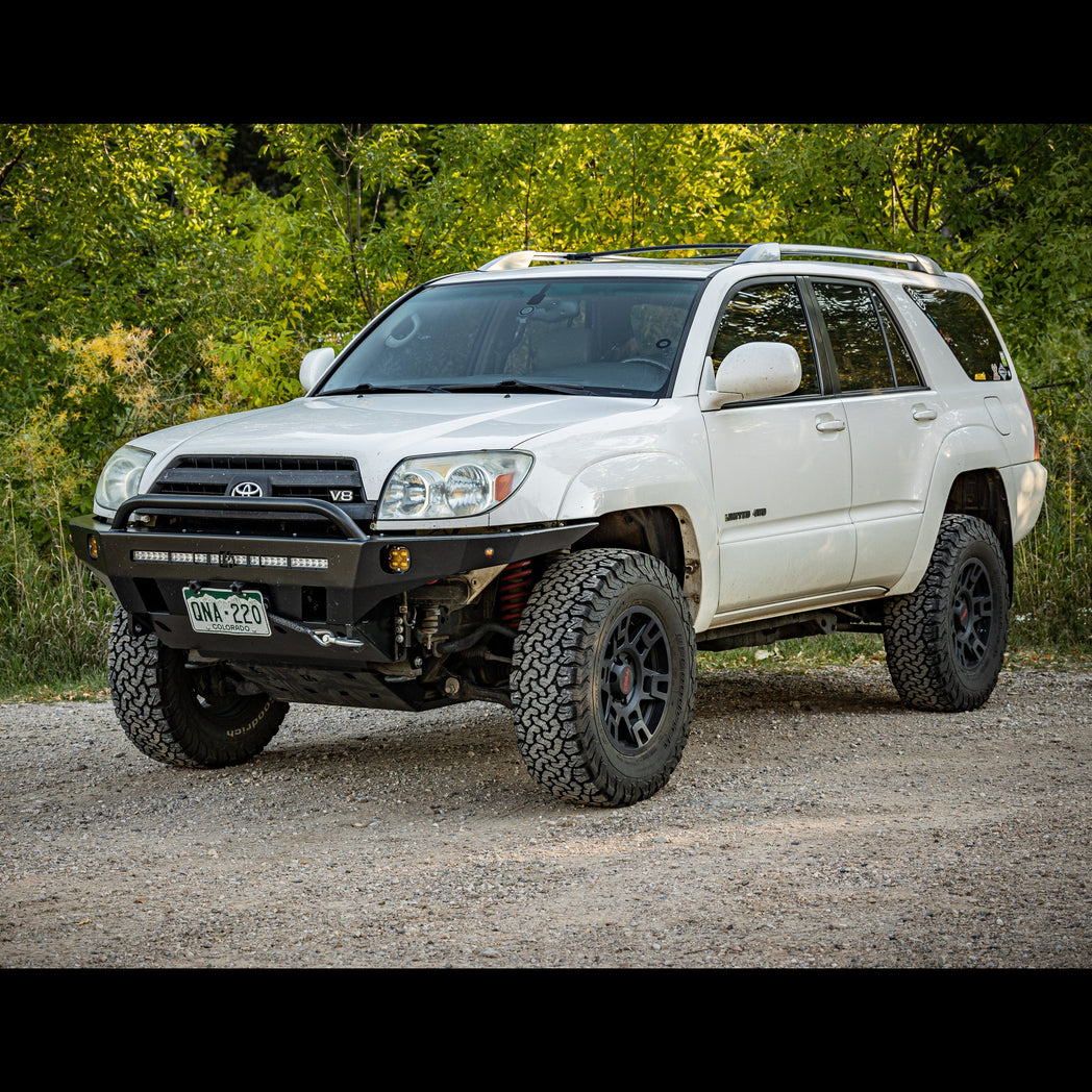 White V8 4Runner with moderate lift and an Overland winch bumper with low bull bar from C4 Fabrication.