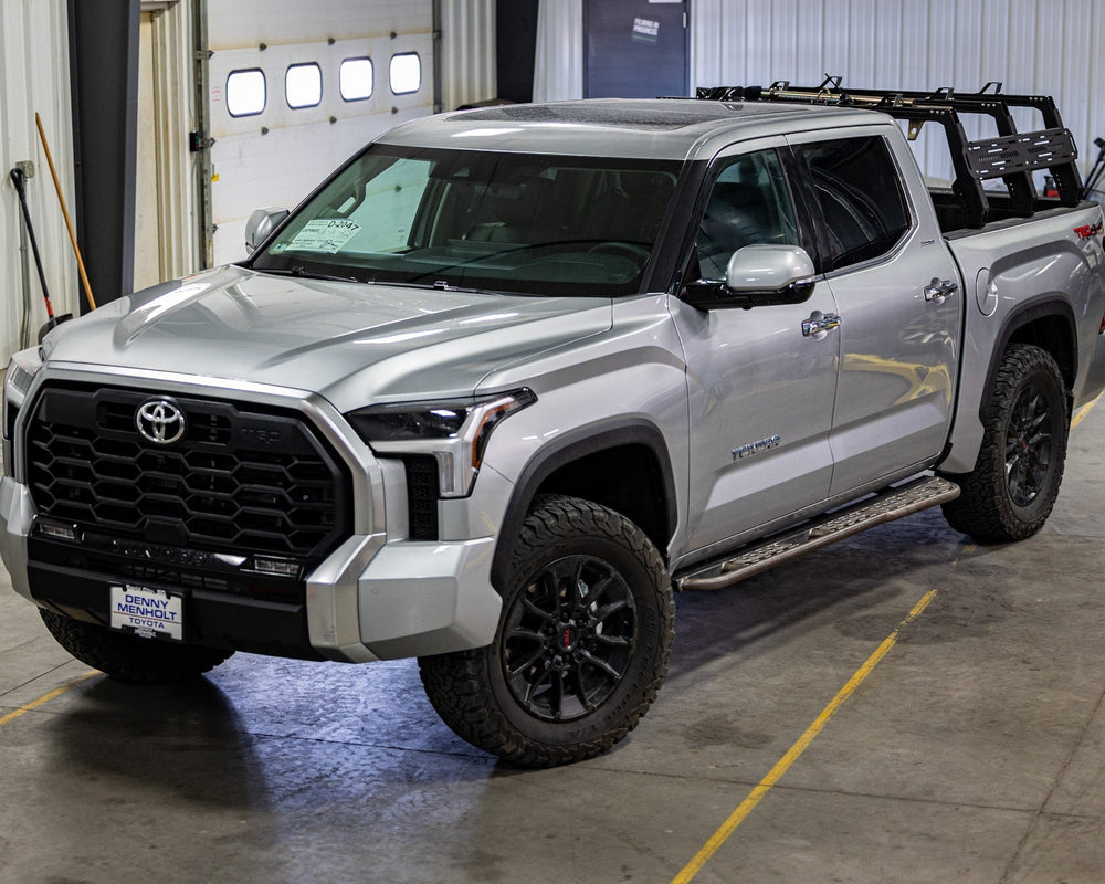 Wide view of a silver 2022+ Tundra equipped with the C4 steel Sliders.