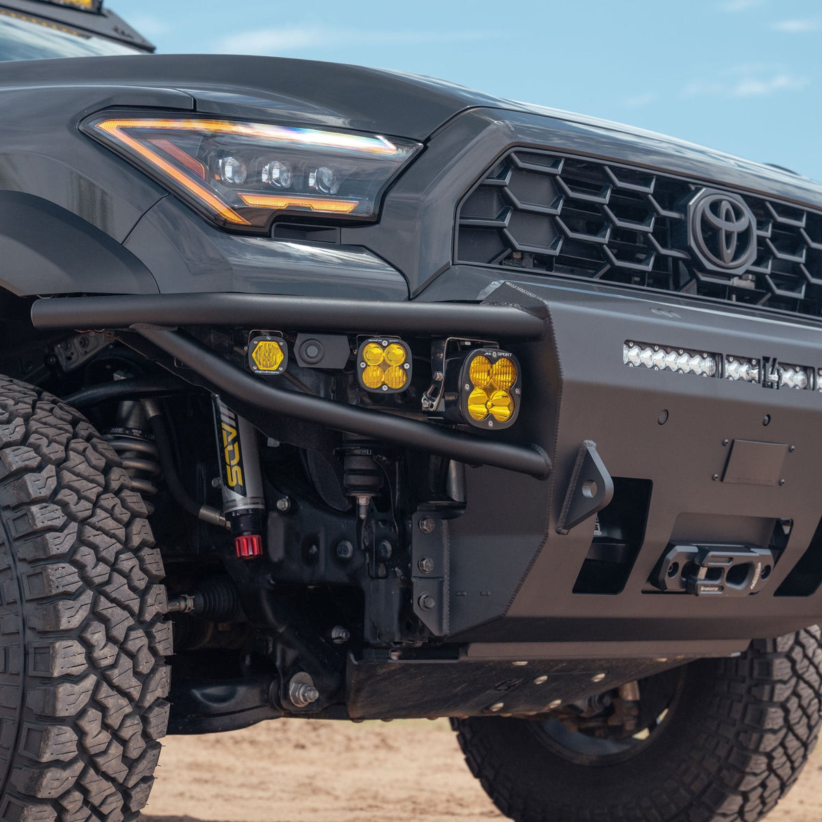 Side angle view of Baja Designs off road lights installed with 6th Gen 4Runner Hybrid Front Bumper by C4 Fabrication