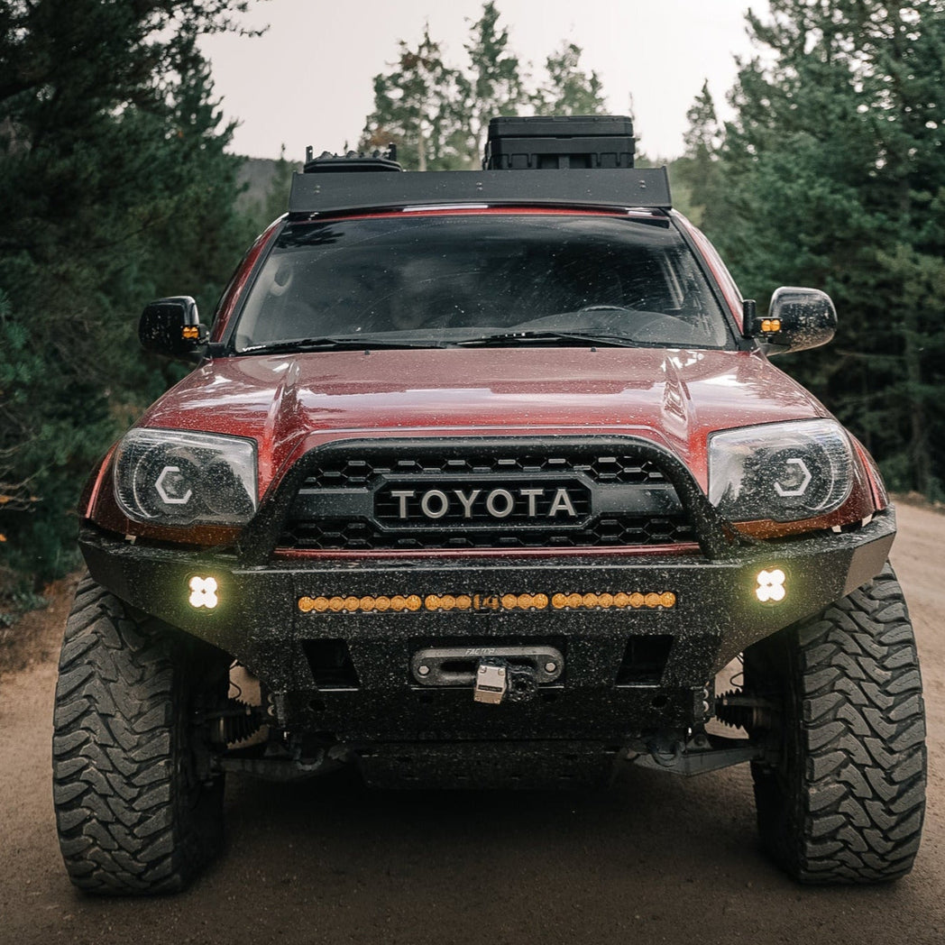 Front view of a maroon 4th Generation 4Runner with a steel C4 Fabrication winch bumper from their Overland Series.