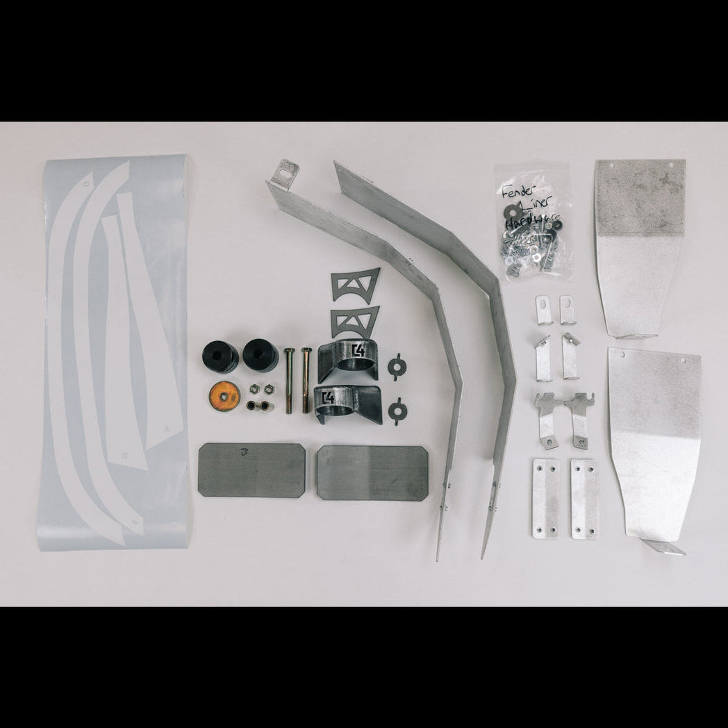 All of the contents of the Oversized Tire Fitment kit laid out on a white table.