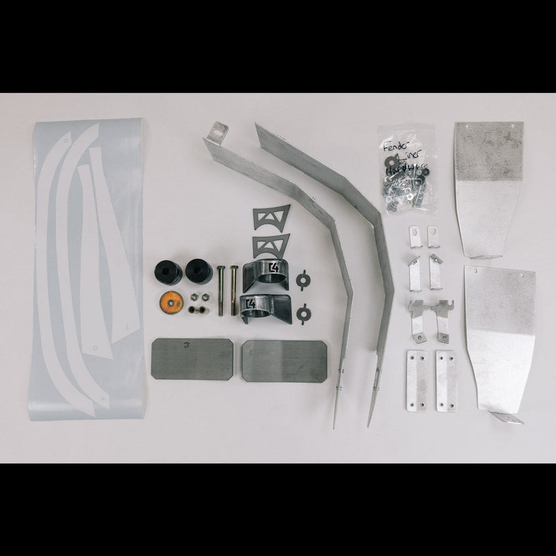 All of the contents of the Oversized Tire Fitment kit laid out on a white table.