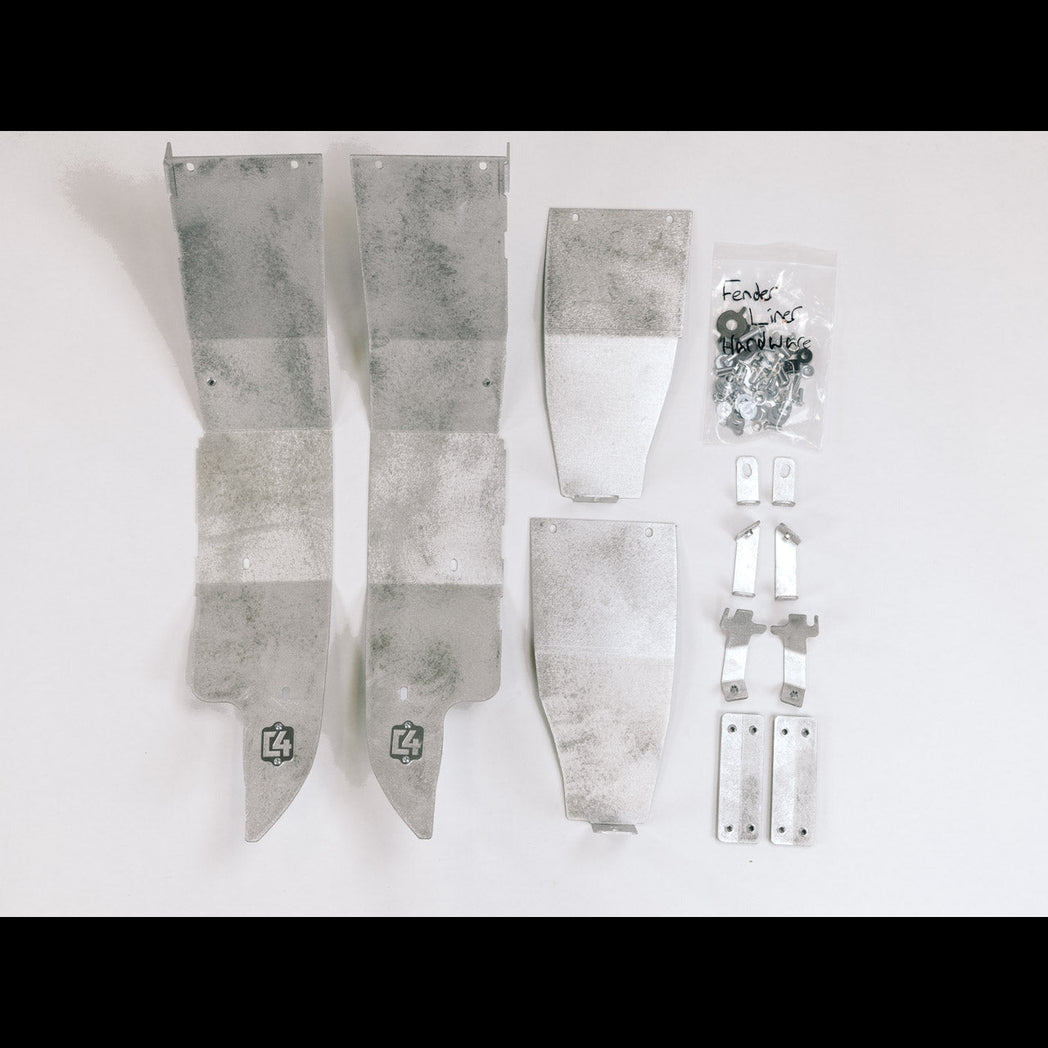 All of the contents of the C4 High Clearance Fender Liner kit laid out on a white table.