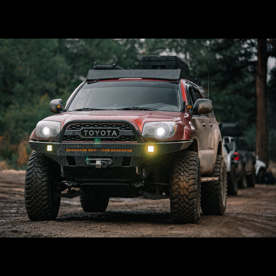 Salsa red pearl 4Runner equipped with a C4 Overland front bumper on an offroading trip in the mountains.