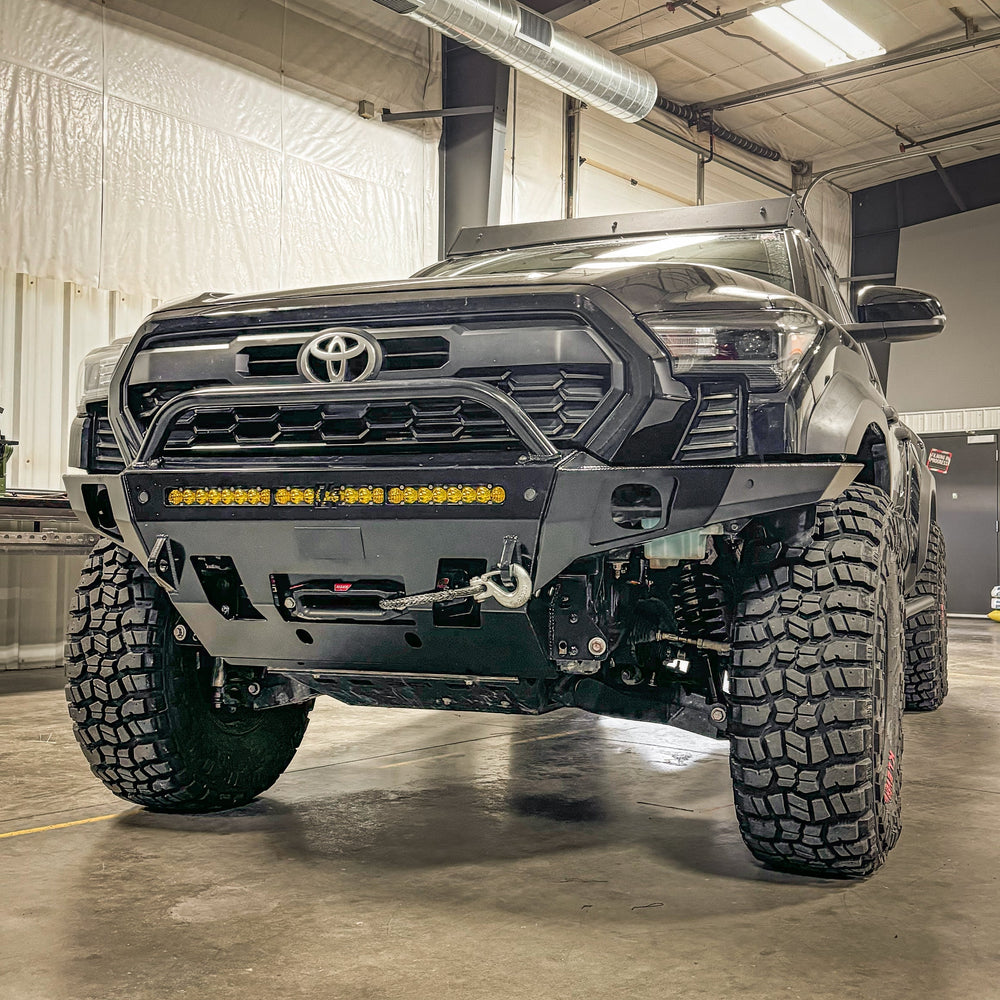 C4 Overland winch bumper with low bull bar installed on a black 2024 Tacoma. 