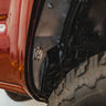 View of the bottom rear portion of the C4 High Clearance Fender Liner kit with the C4 logo. 