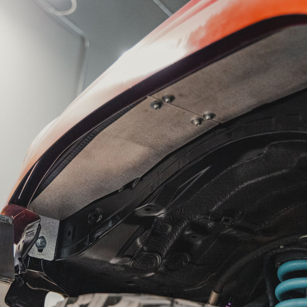 View from a low angle looking forward at the front portion of the High Clearance Fender Liner Kit from C4 Fabrication.
