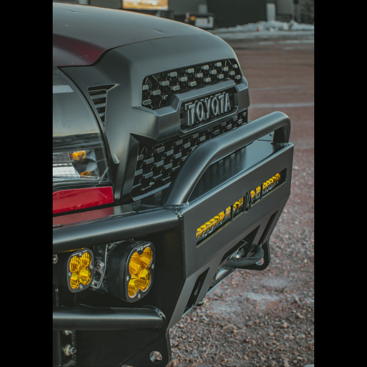 Close up quartering view of the front face of the C4 Hybrid front bumper and mid-height bull bar for the 2nd Gen Tacoma.