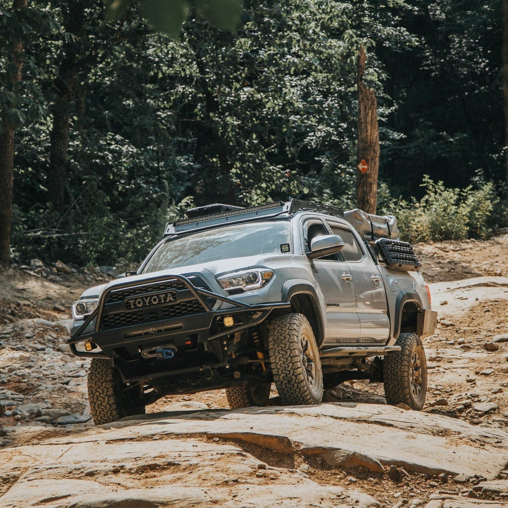 Baby blue four-door Tacoma fully outfitted for overlanding and with a C4 Hybrid front winch bumper.