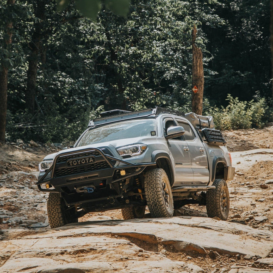 Baby blue four-door Tacoma fully outfitted for overlanding and with a C4 Hybrid front winch bumper.