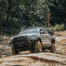 Baby blue four-door Tacoma fully outfitted for overlanding and with a C4 Hybrid front winch bumper.
