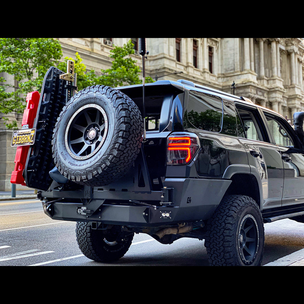 Low-angle quartering view of the C4 Fabrications rear bumper for 2010-2024 4Runners equipped with dual swing-outs for spare tire and accessories. 