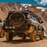 Passenger side rear view of the Overland rear bumper for the 4Runner from C4 Fabrications, showing off its half-width spare tire swing option. 