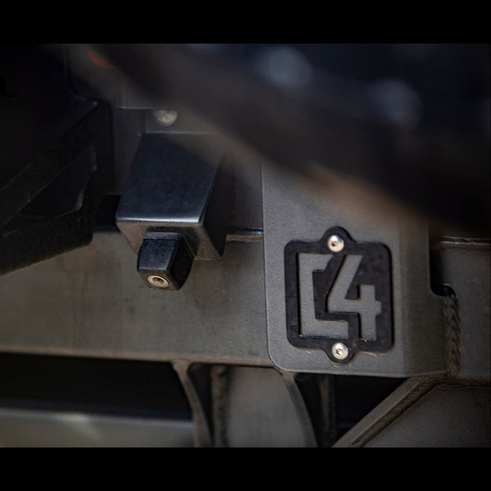 Close-up view of the C4 logo on the 4Runner rear bumper.