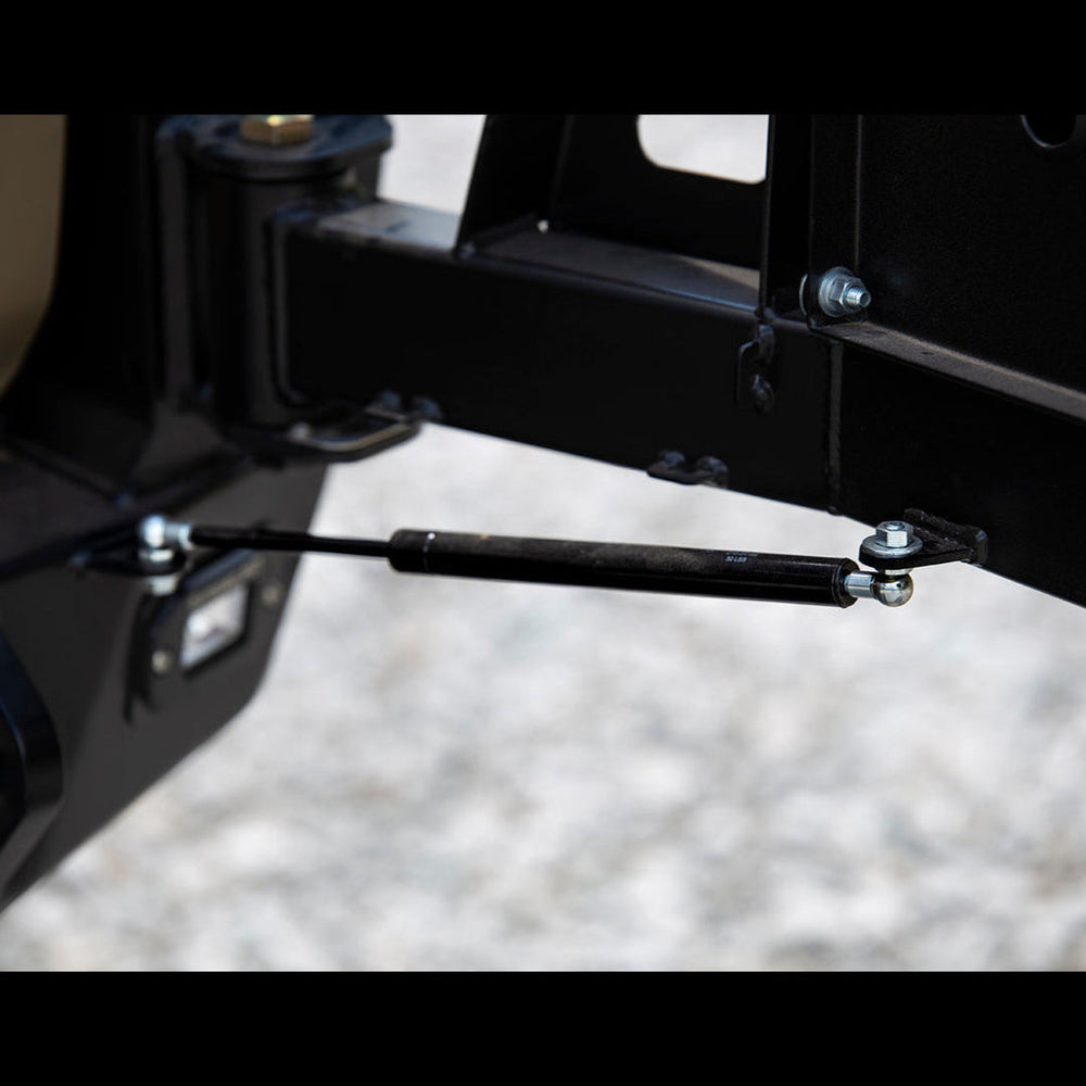 Close-up view showing the gas strut on the C4 swing-out bumper.