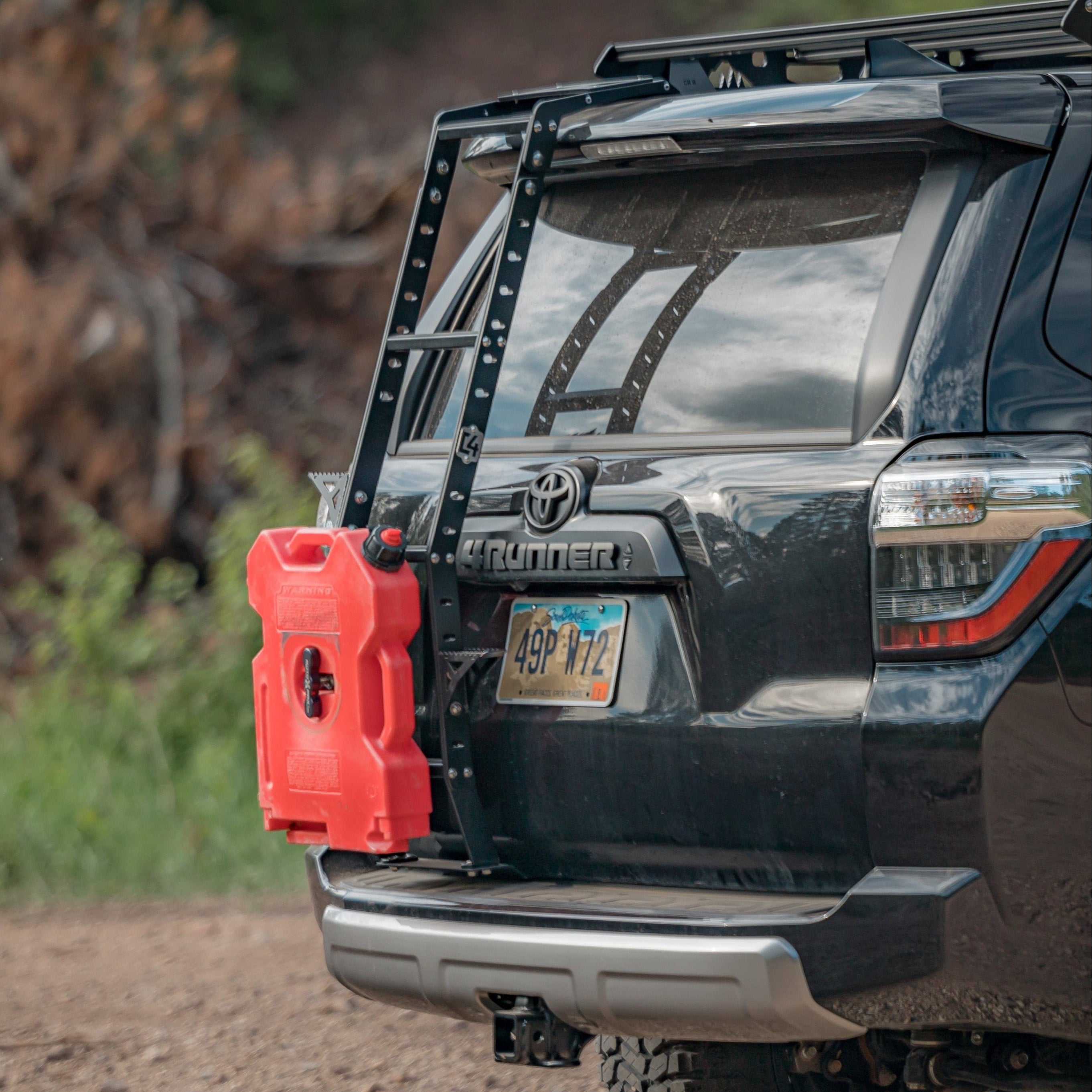 Black 4Runner equipped with a Summit hatch ladder from C4 as well as a RotopaX fuel container.