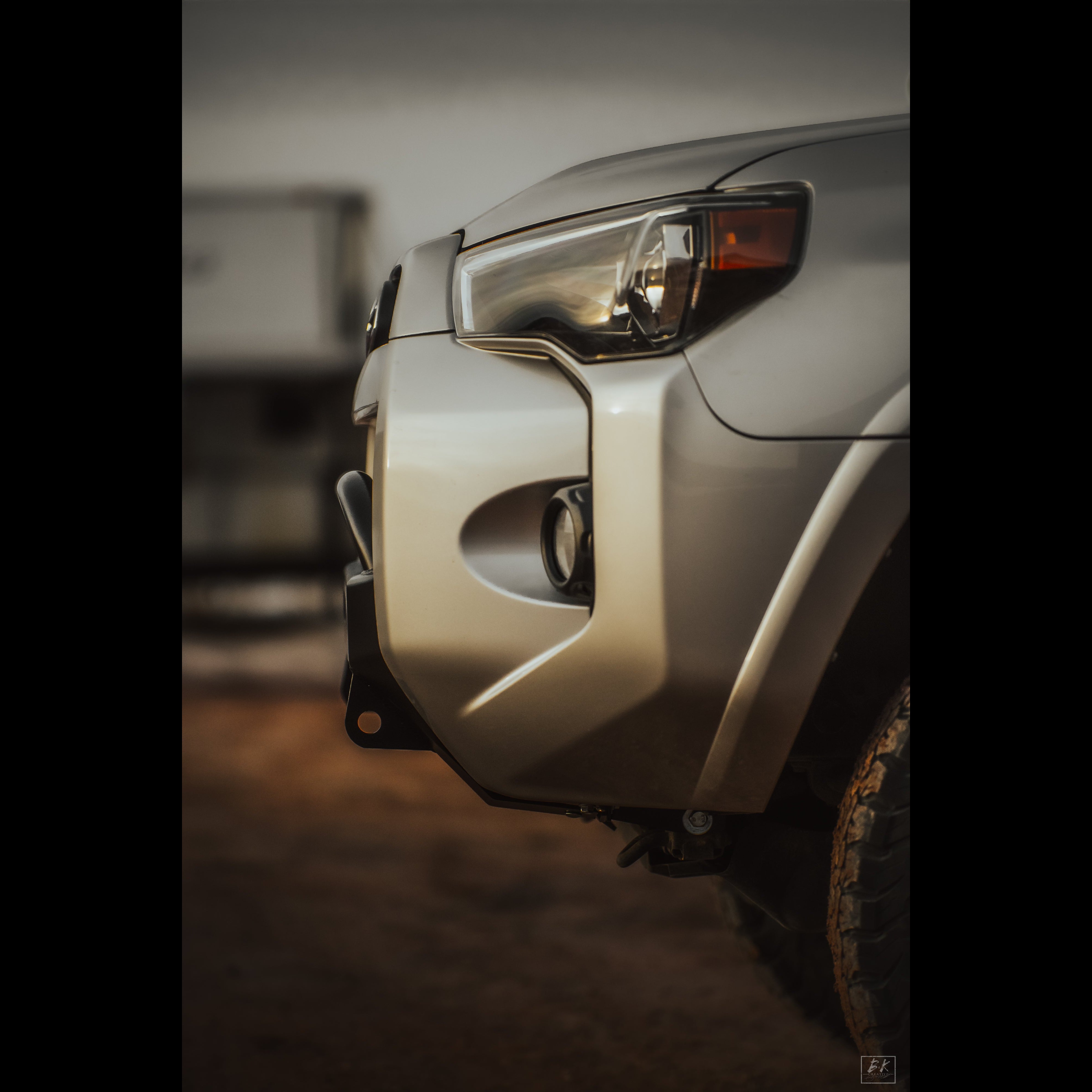 Side view of the C4 Lo-Pro bumper with medium-height bull bar installed in a silver 4Runner showing the minimal distance that the bumper and bull bar protrude from the surrounding bodywork.