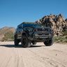 Black Toyota 6th Gen 4Runner with C4 Lo Pro Front Bumper on a dirt road with rocky mountains in the background