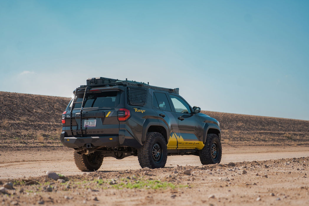Off-road vehicle with roof rack in a desert landscape and Rear Hatch Ladder on the 6th Gen 4Runner