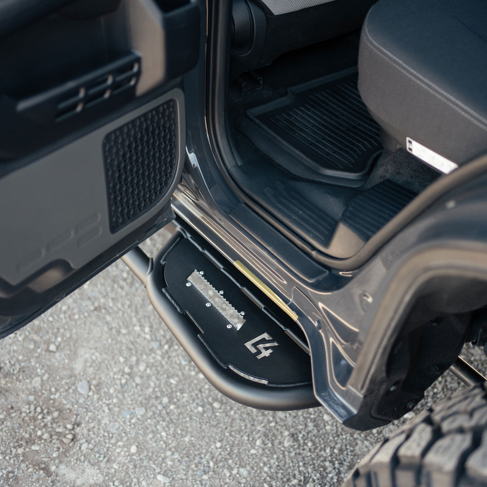 Rock sliders for the 6th Gen Toyota 4Runner viewed with the rear door open.