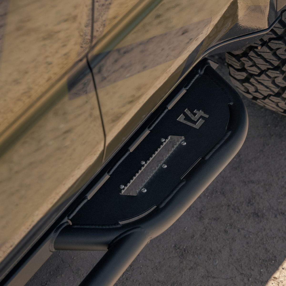 Close-up of Rock sliders for the 6th Gen Toyota 4Runner with C4 logo on a desert background