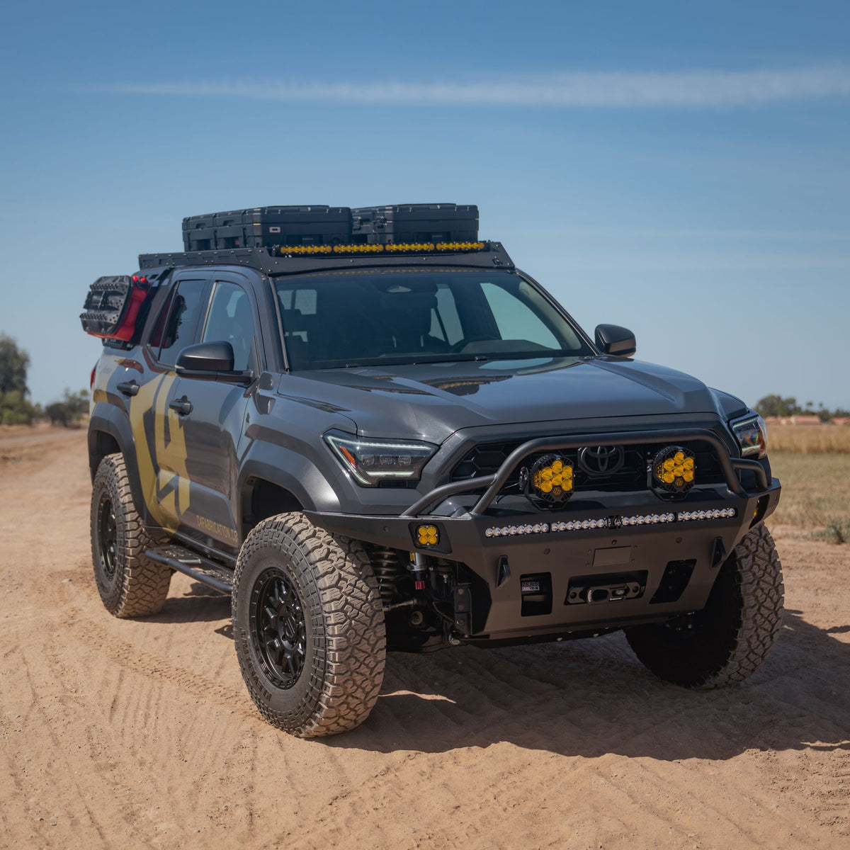 Overland Series Front Bumper for the 6th Gen 4Runner on sandy dirt road. 4Runner is also equipped with roof rack and exterior molle panels.