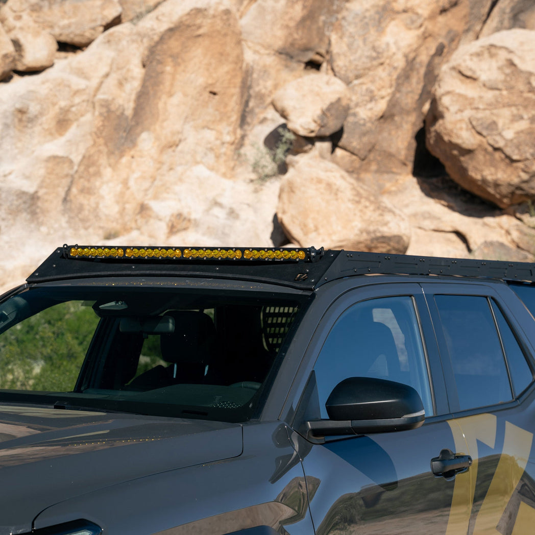 6th Gen 4Runner Roof Rack with a 40" light bar in front of rocky terrain