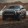 Black Toyota 2022 Tundra equipped with a C4 Overland front winch bumper with mid-height bull bar with tube gussets.