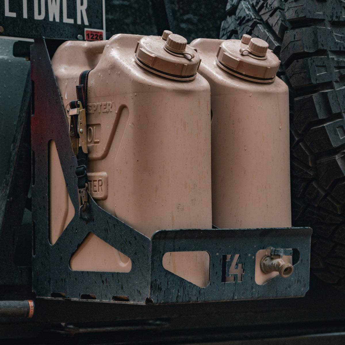Cover photo for the dual jerry can carrier from C4 Fabrication with emphasis on the carrier and the background faded out.
