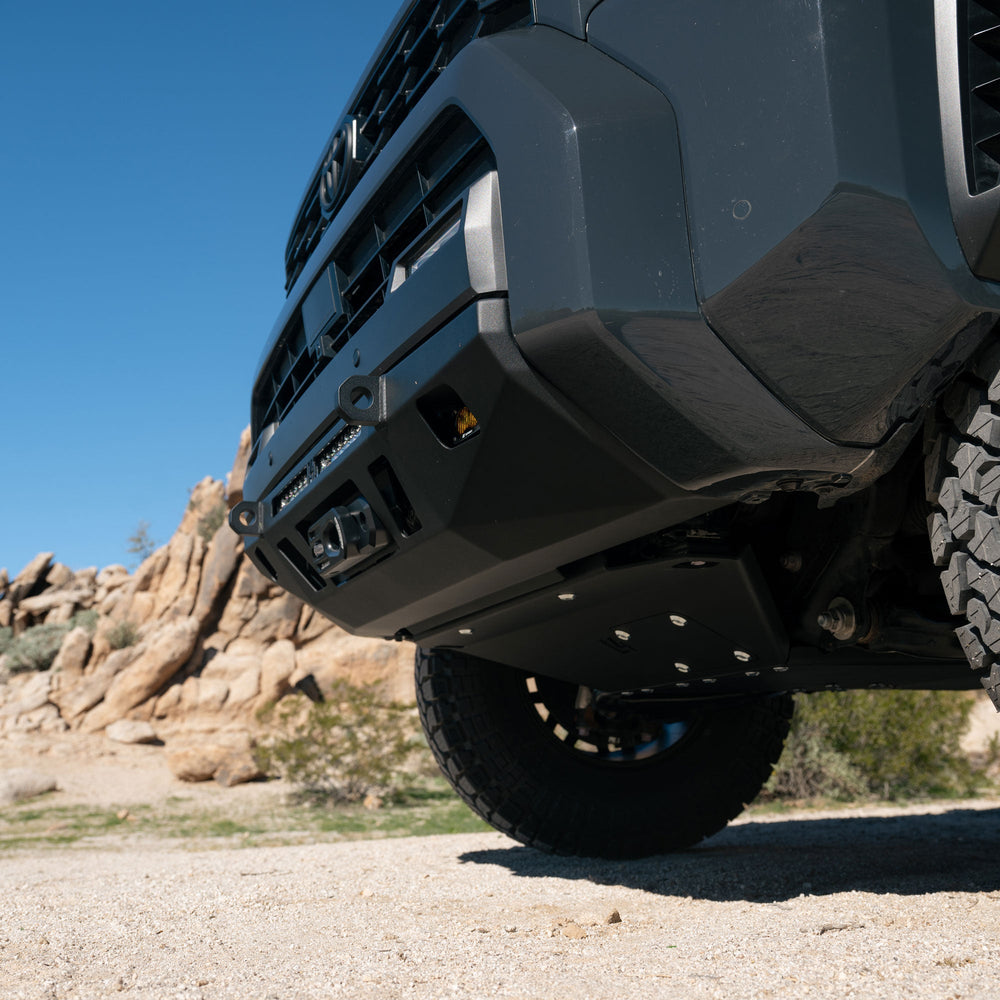 Close-up of a C4 Winch Fairlead Closed Hook on off-road vehicle in a desert landscape with rocky formations.