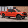 Side angle of the C4 Hybrid bumper installed on a red Tundra Crewmax. 