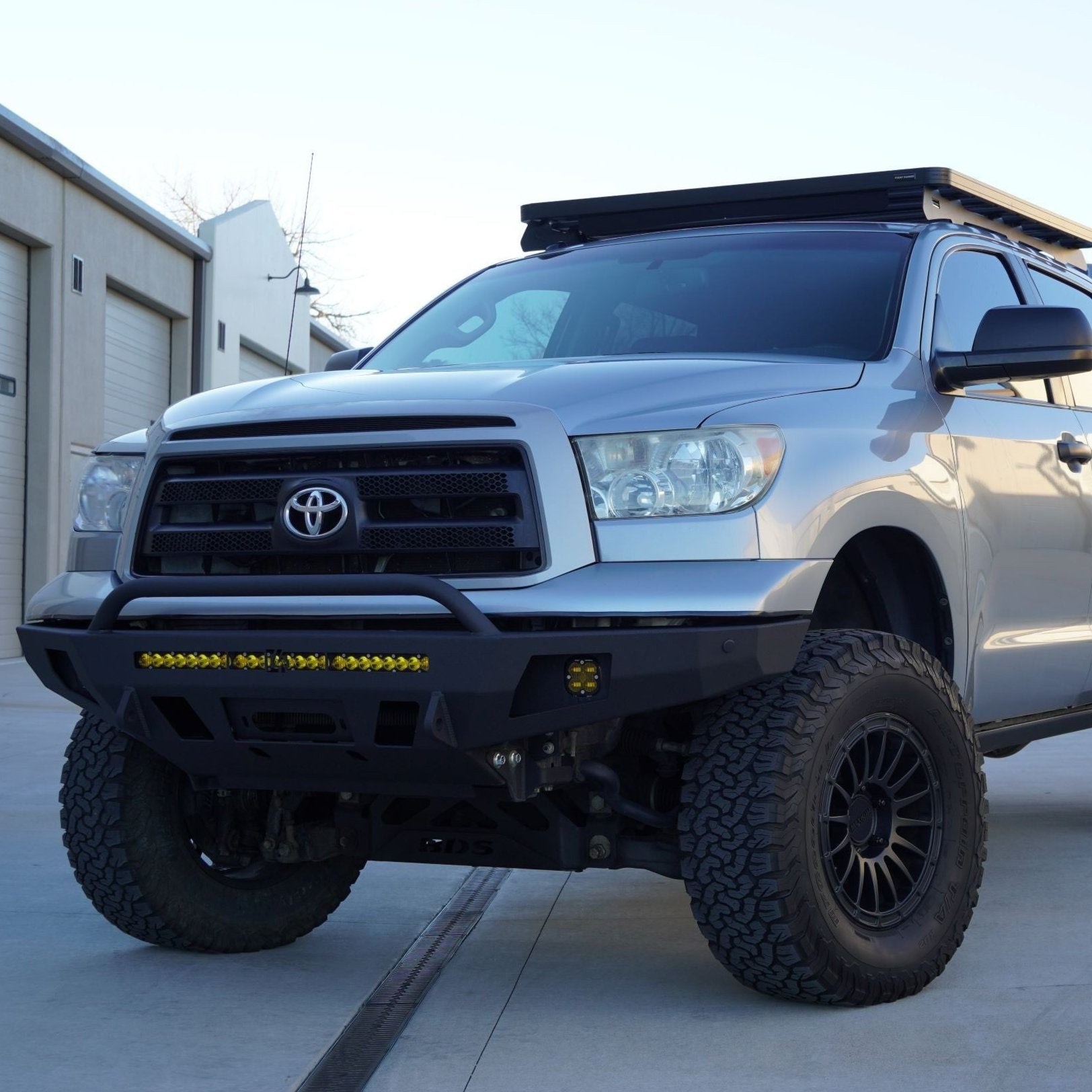 C4 Overland bumper on an early 2nd Gen Tundra with fog lights and light bar installed.