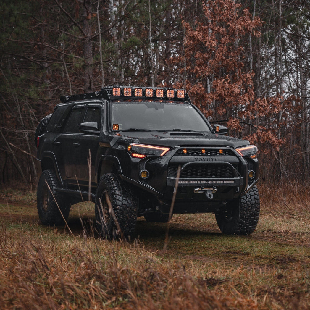 Quartering on photo of a black 2014 4Runner with the C4 Lo-Pro bumper and high clearance additions.