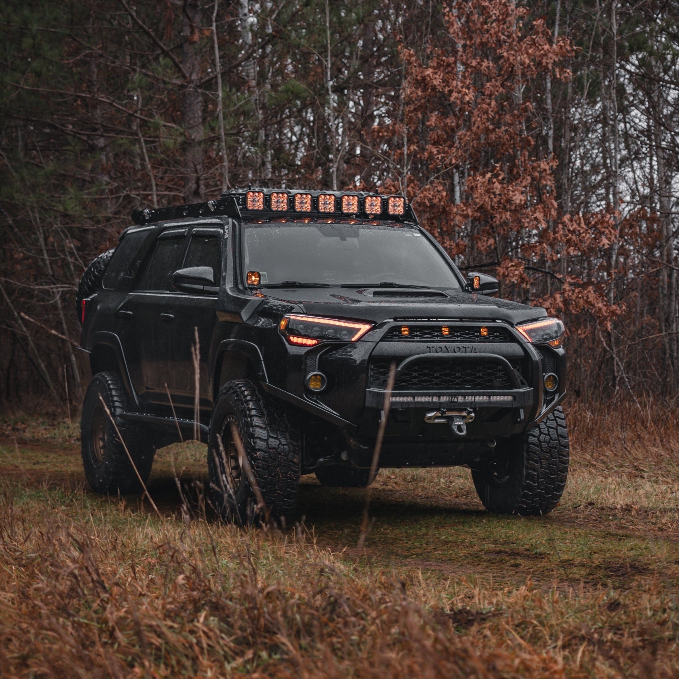 Quartering on photo of a black 2014 4Runner with the C4 Lo-Pro bumper and high clearance additions.