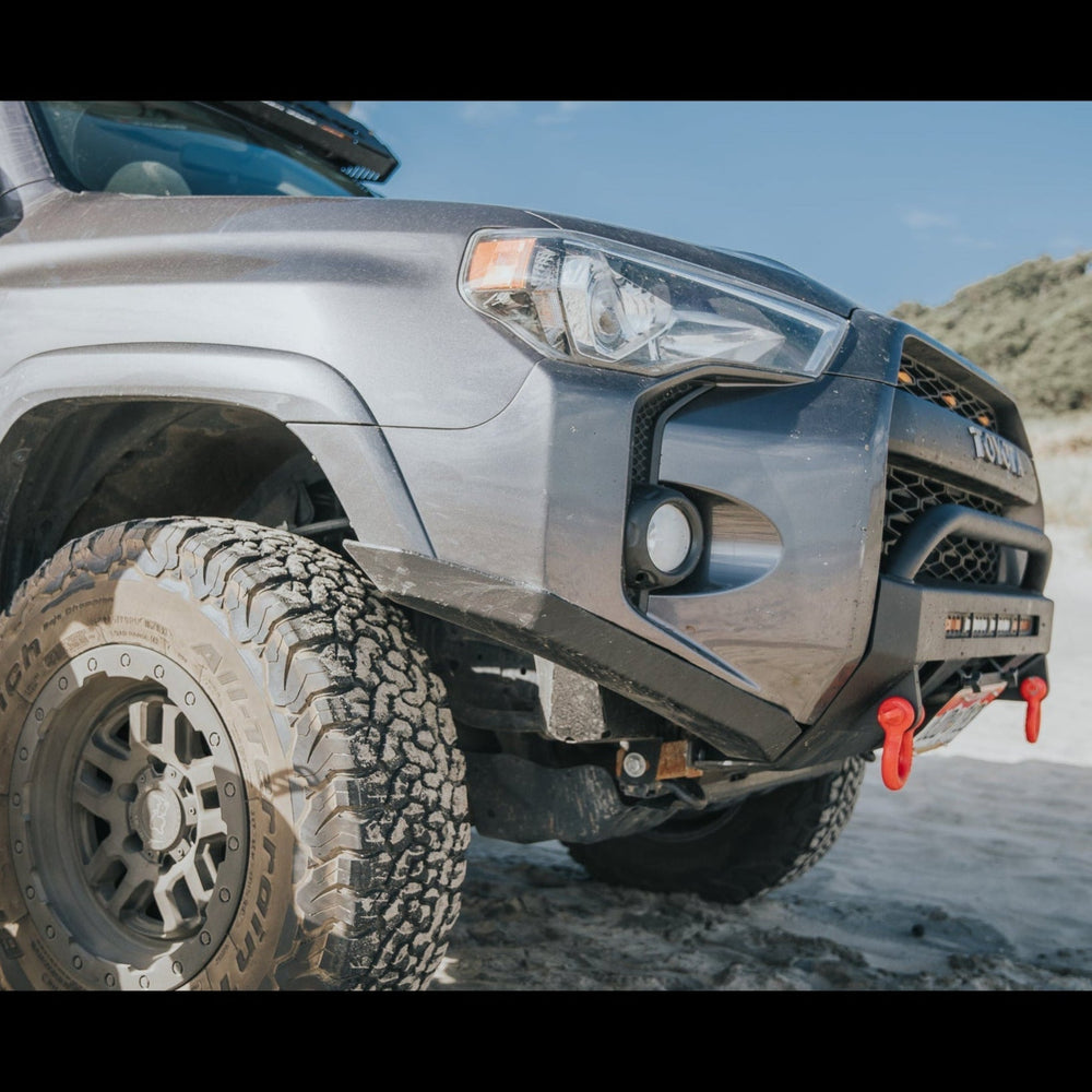 Close-up of the High Clearance Additions from C4 Fabrication on a grey 4Runner at the beach. 