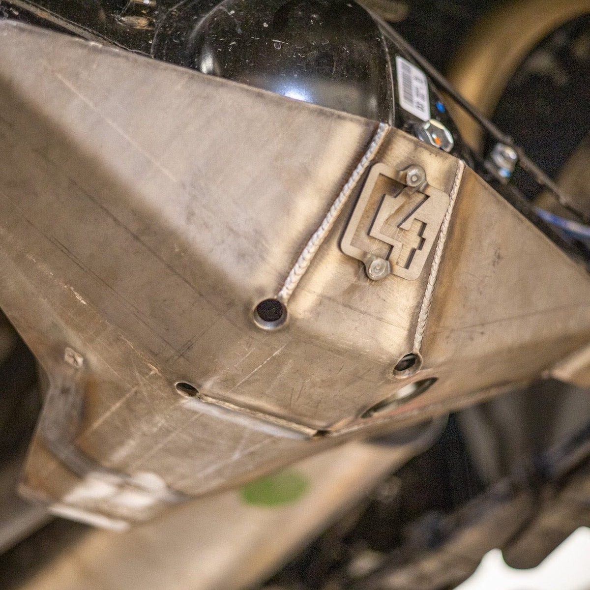 Cover photo for the rear diff skid for the 3rd Gen Tacoma with the skid emphasized and the rest of the photo faded out.
