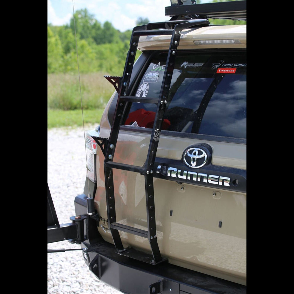 Rear view of a tan 4Runner equipped with a C4 Fabrication dual swing-out rear bumper and the Summit hatch ladder with accessory side steps. 