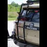 Rear view of a tan 4Runner equipped with a C4 Fabrication dual swing-out rear bumper and the Summit hatch ladder with accessory side steps. 