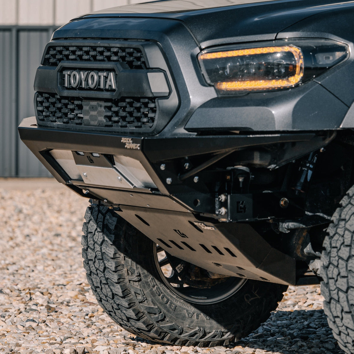 Cover photo for the Rock Runner Front Skid with Crossmember Delete for the 3rd Gen Tacoma with emphasis on the skid and crossmember and the rest of the photo faded out.