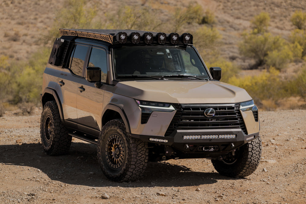 Beige Lexus GX 550 with off-road equipment in a desert setting