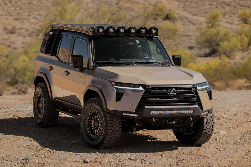 Beige Lexus GX 550 with off-road equipment in a desert setting