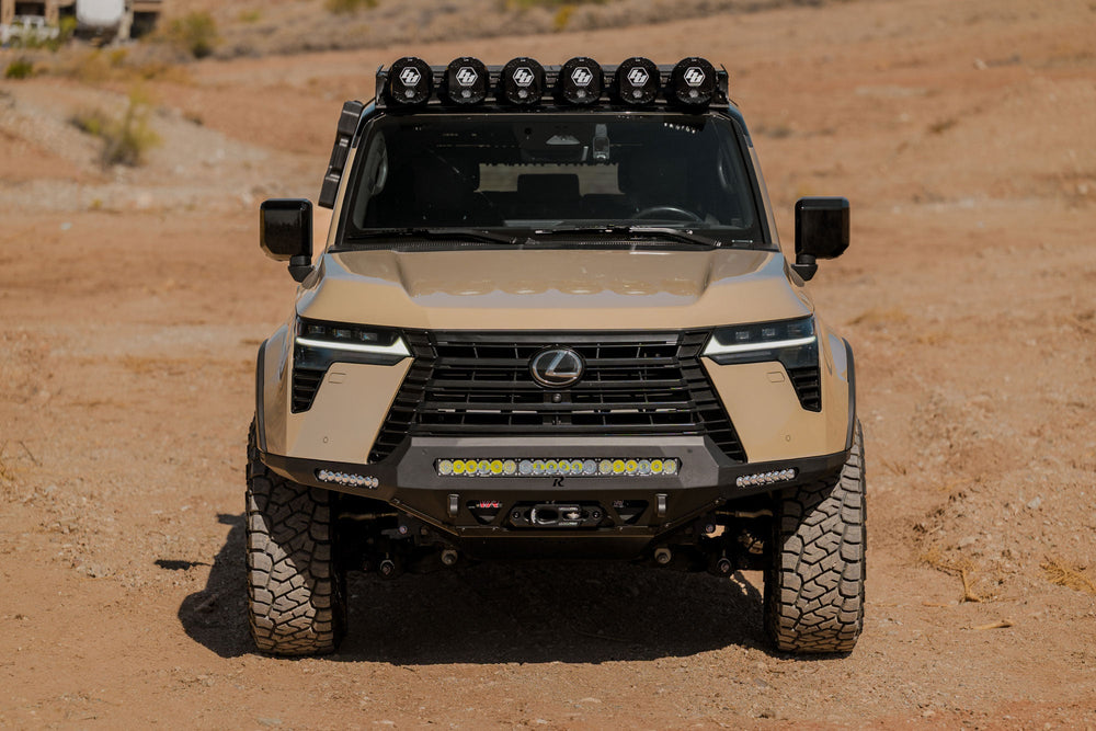 Front view of the GX 550 with off road bumpers, roof rack, and molle panels.