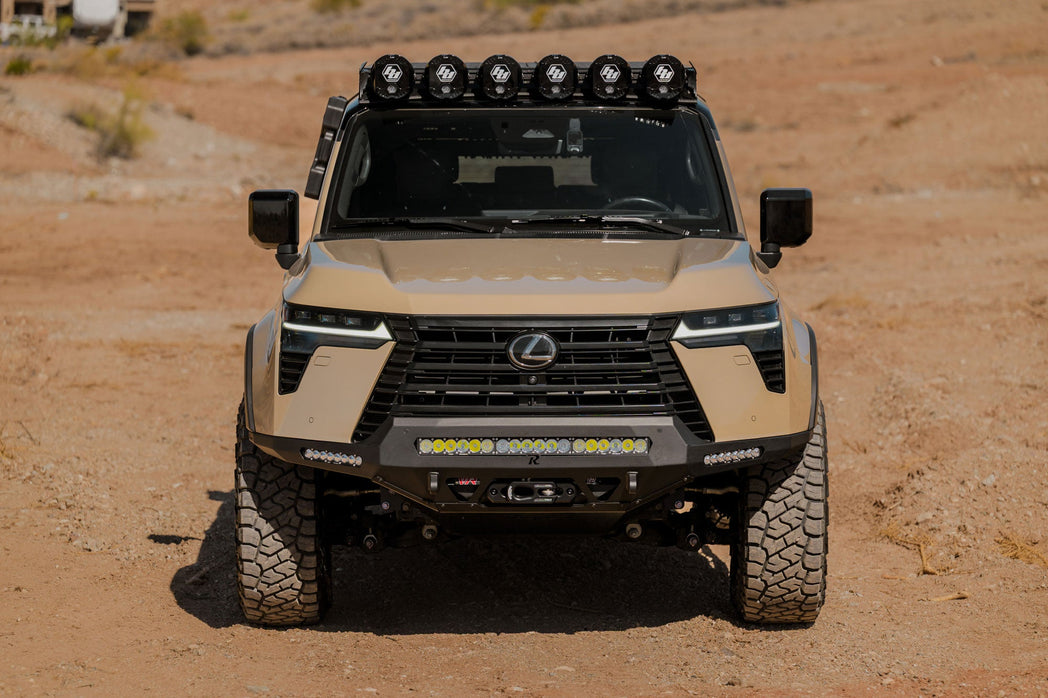Front view of the GX 550 with off road bumpers, roof rack, and molle panels.