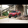 Red 4Runner parked in an industrial lot equipped with C4 Lo-Pro bumper and High Clearance Additions.