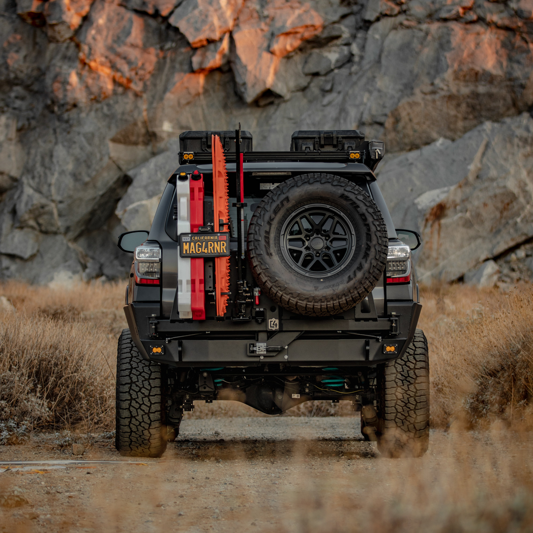 Rear view of a well-modified 5th Generation 4Runner that shows off the C4 Fabrications Overland Rear Bumper with dual swing-outs for its oversized spare tire and accessories. 