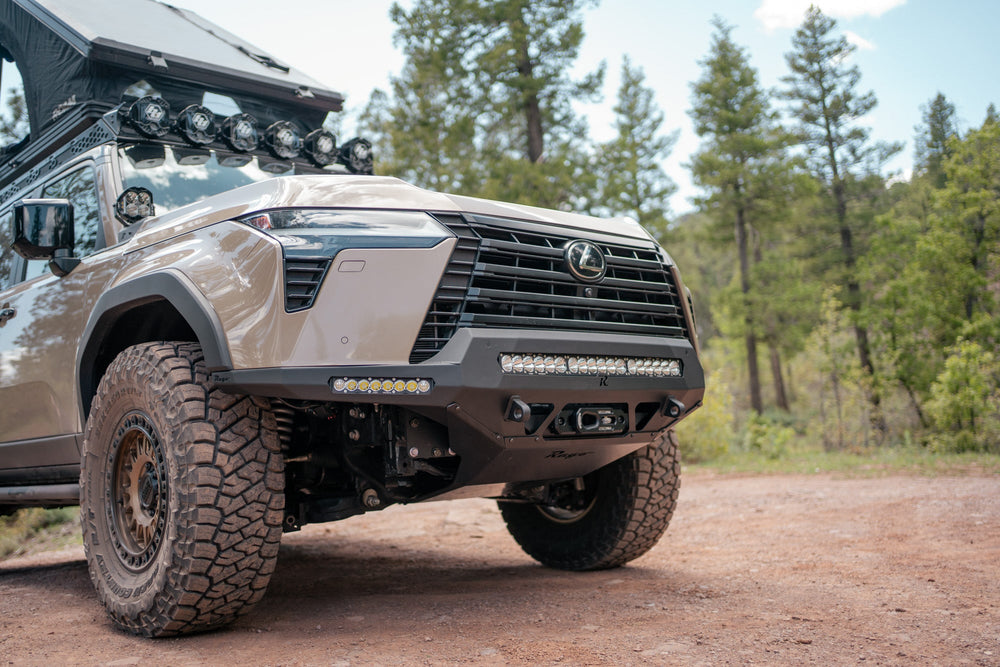 GX 550 fully equipped on camping trip with off road bumpers, roof rack, tent, light brackets, Skid plate, and molle panels.